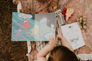 un petit garcon lit un libre dans herbe au parc de vaugrenier