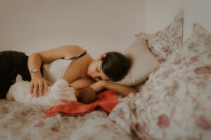 durant shooting photo nouveau-ne on prend le temps d'allaiter bebe allonges sur le lit