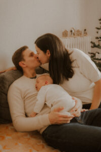 de jeunes parent montrent leur amour en s'embrassant durant la seance photo naissance de leur bebe